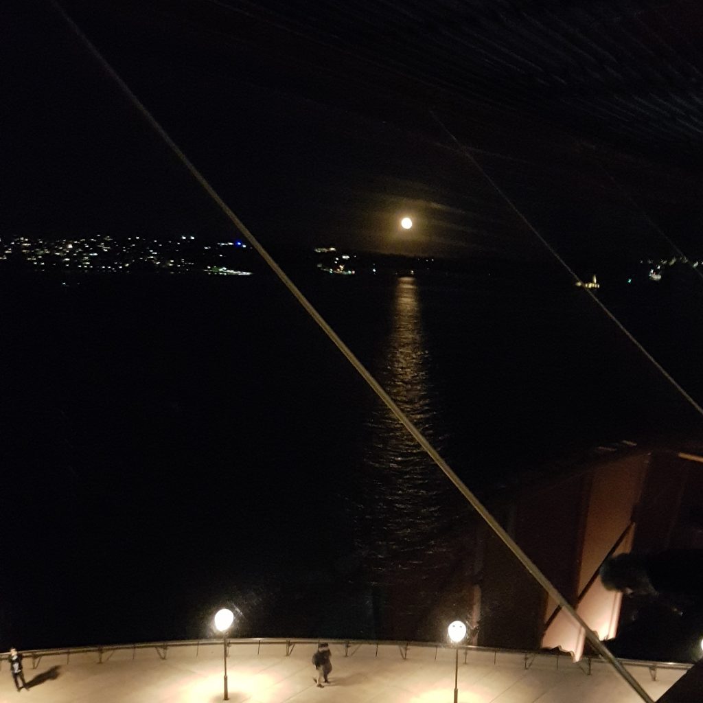 almost a full moon over sydney harbor